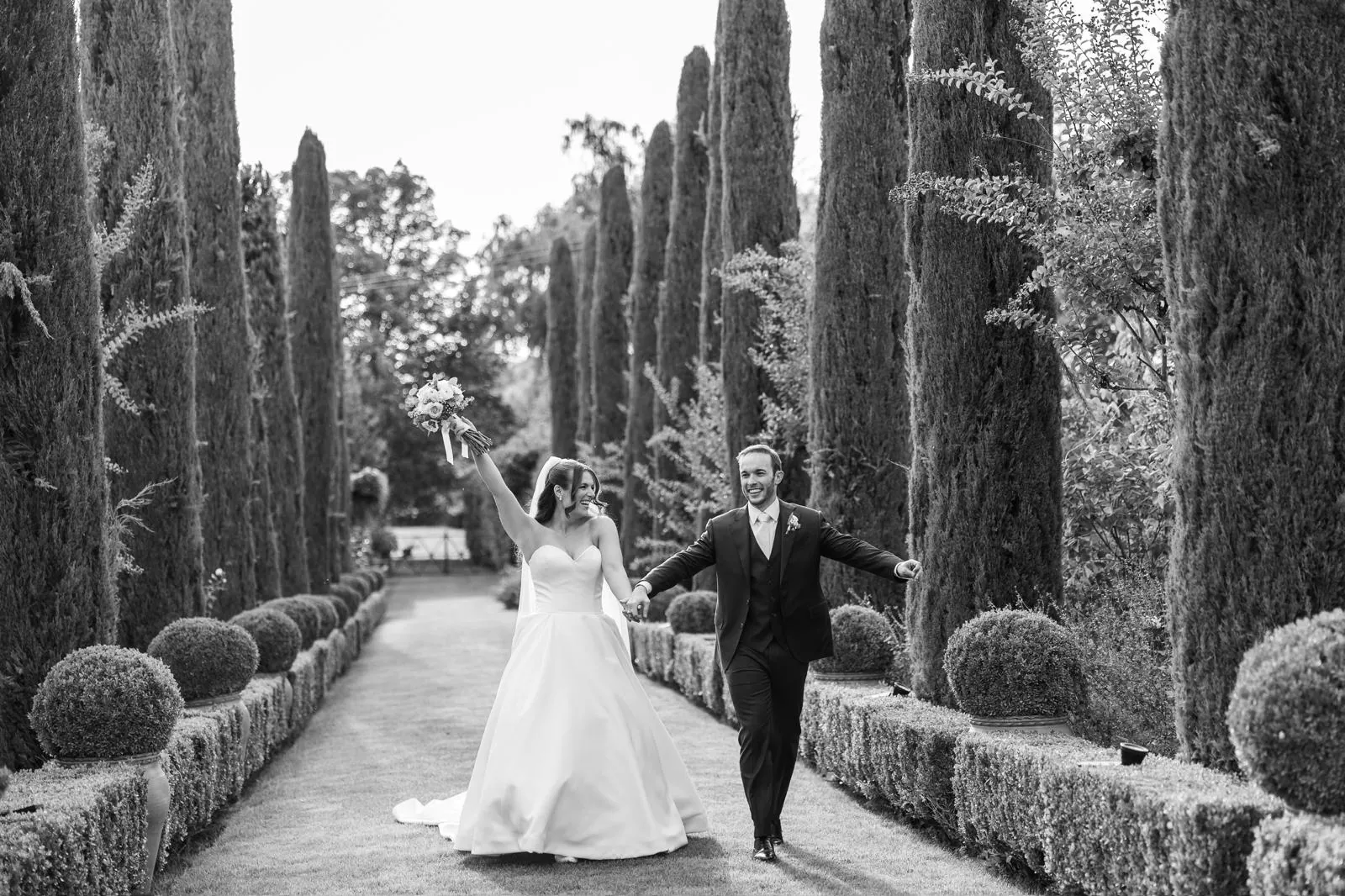 Cristina and Alberto walking along the cypress avenue