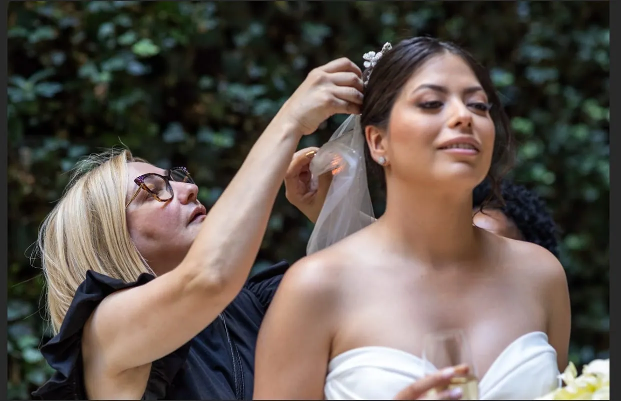 Mercedes arranging a bride’s veil